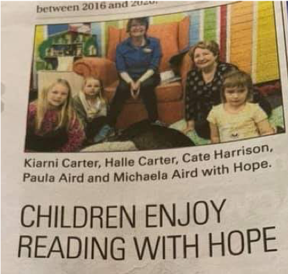 Children reading with Hope, the greyhound newspaper clipping 